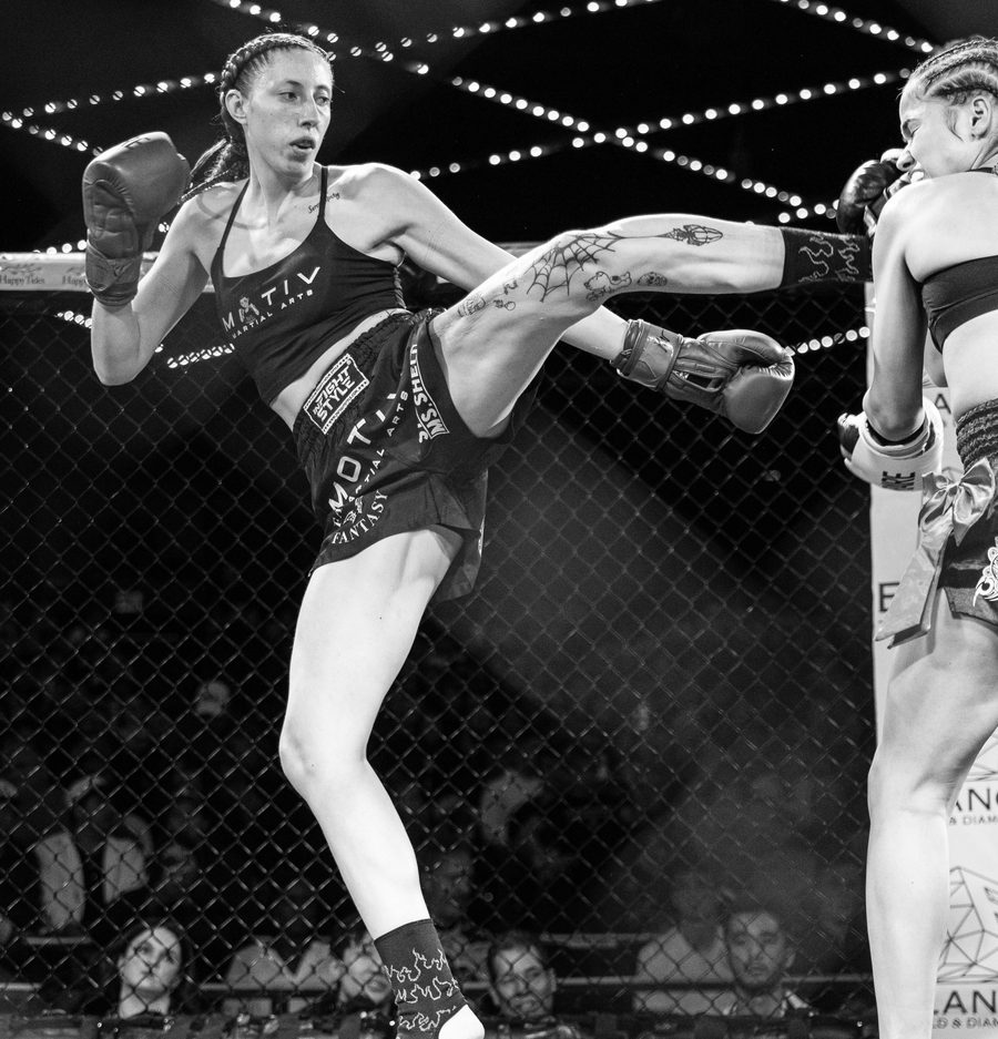 Annika Kahl landing a kick in the cage on fight night